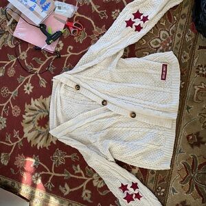 Taylor Swift Cream Cardigan with Red Star Accents